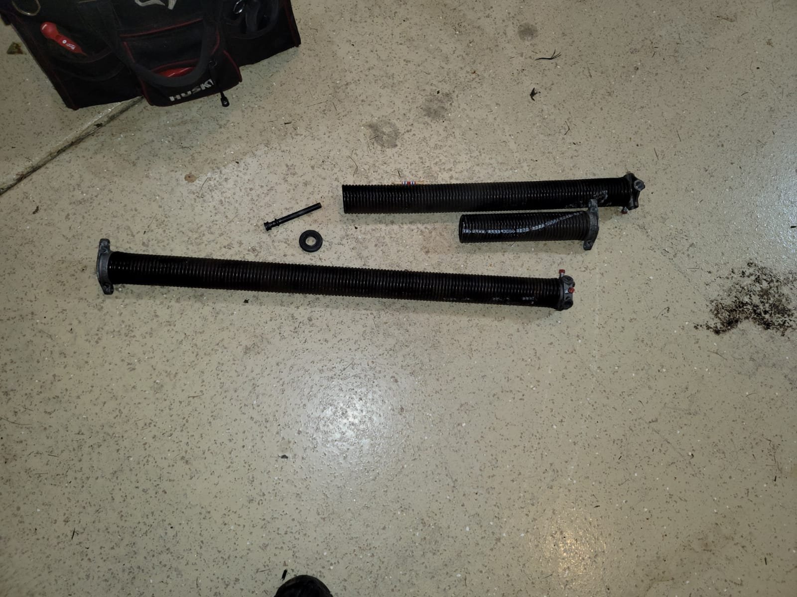 a professional technician from Bexley Garage Door Repair expertly replacing a garage door spring, showcasing the precision and care taken during the repair process.